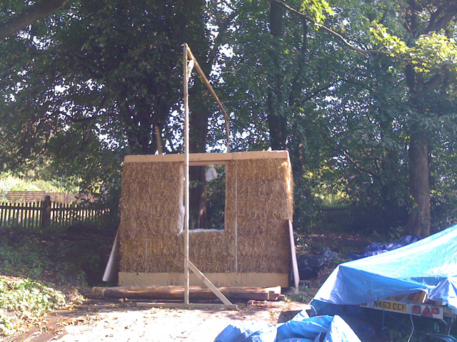 The tarp frame over the straw building
