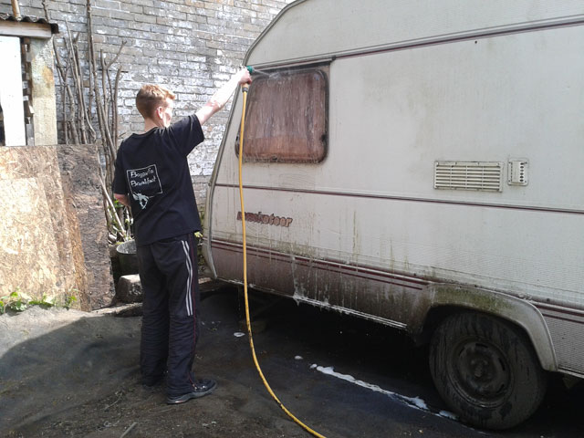 Lucy washing the caravan